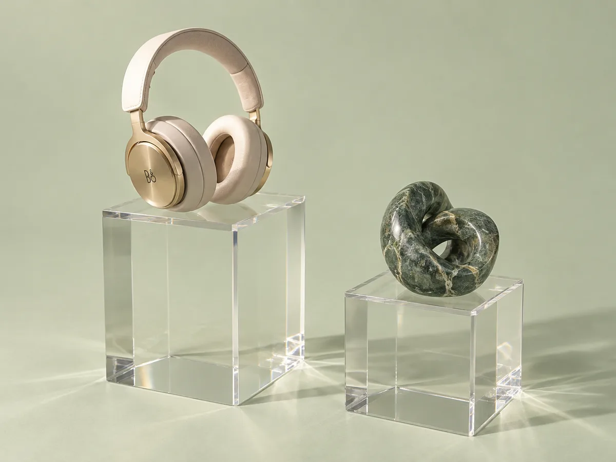 Clear acrylic display pedestals holding headphones and an object