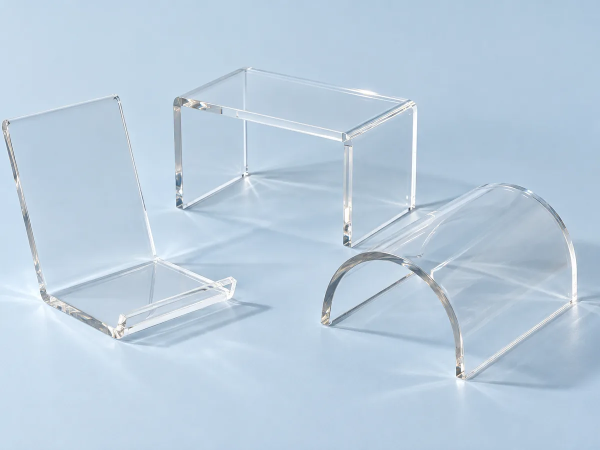 Heat-bent clear acrylic parts: an L-shaped stand, a U-shaped riser and a curved cover