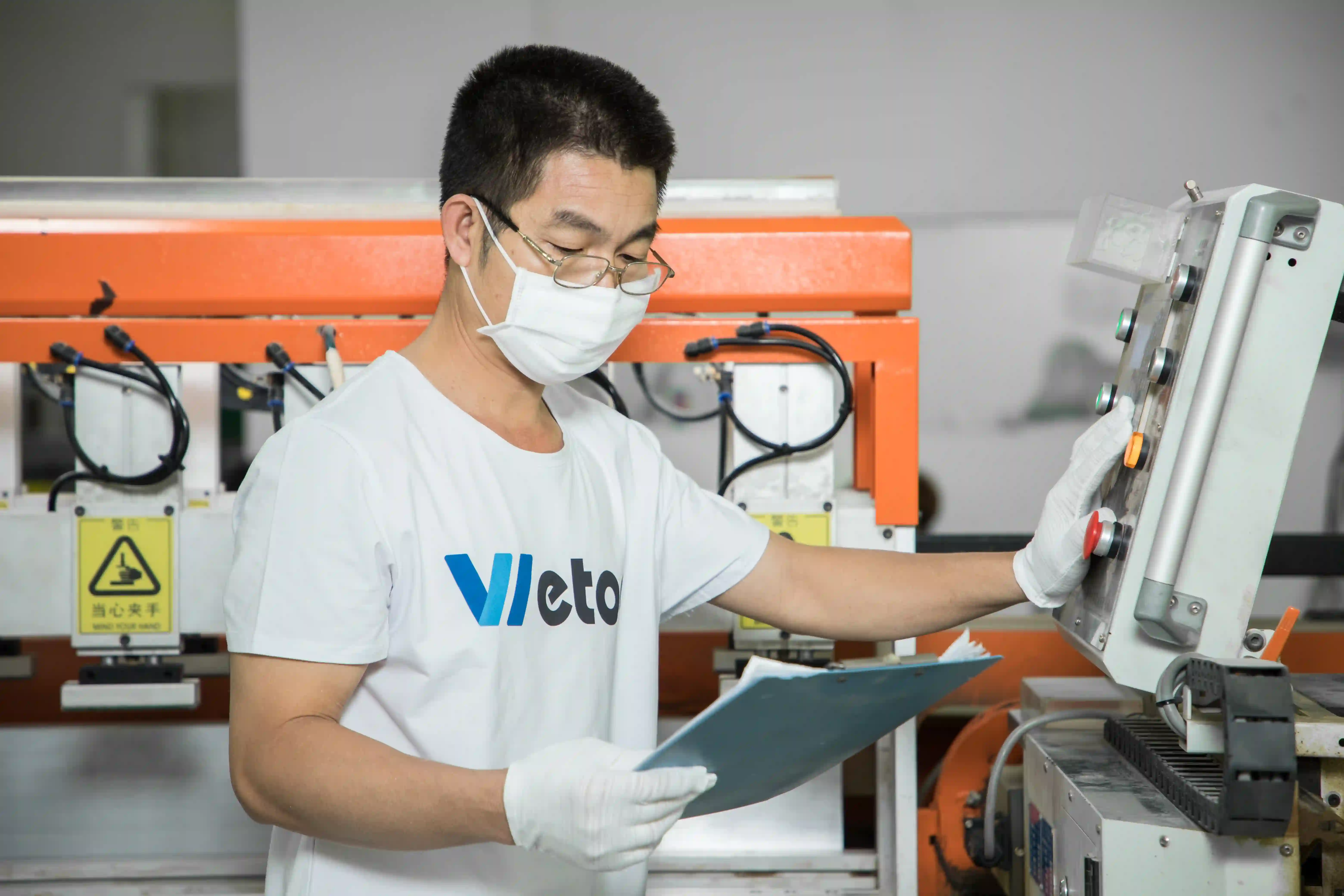 Wetop Acrylic engineer hand-finishing an acrylic part at a workstation