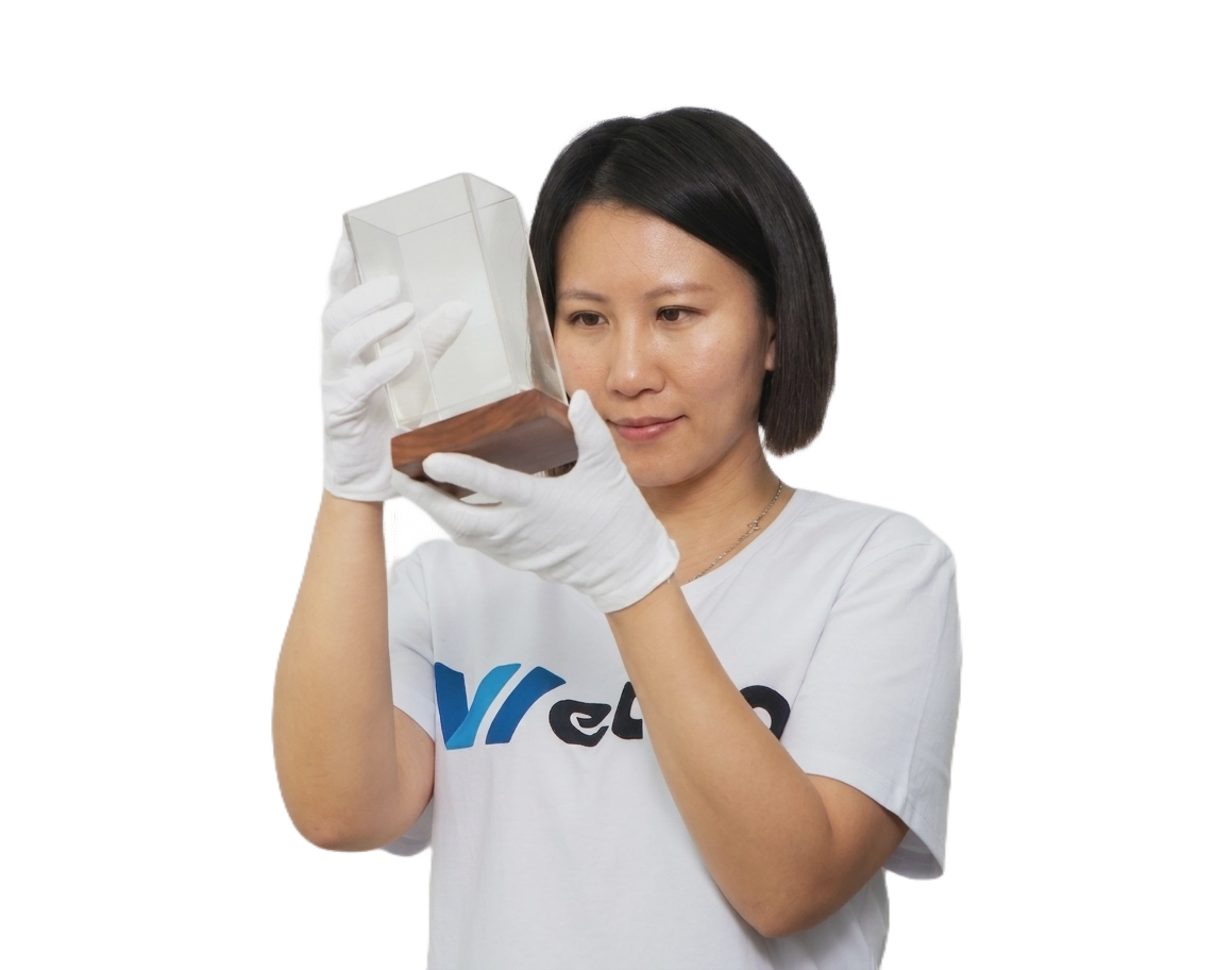 Wetop Acrylic craftsman carefully inspecting a custom acrylic product on the factory floor