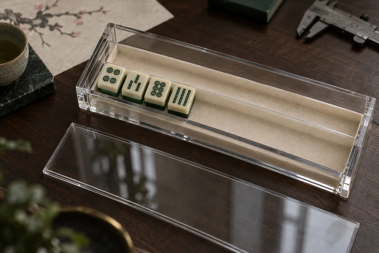 Open acrylic case with a divider, separate sliding lid and four sample tiles