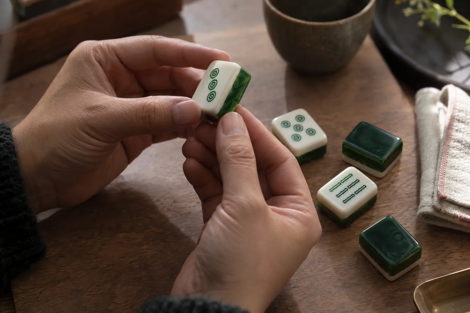 Illustration of hands checking the polished edge and layers of an acrylic mahjong tile