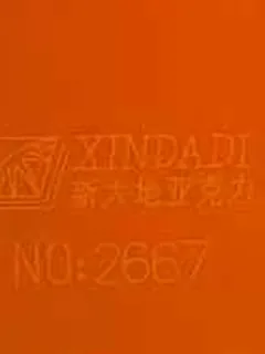 Photographed Xindadi cast acrylic chip, code 2667, opaque bright orange