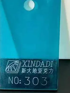 Photographed Xindadi cast acrylic chip, code 303, translucent cerulean blue tint