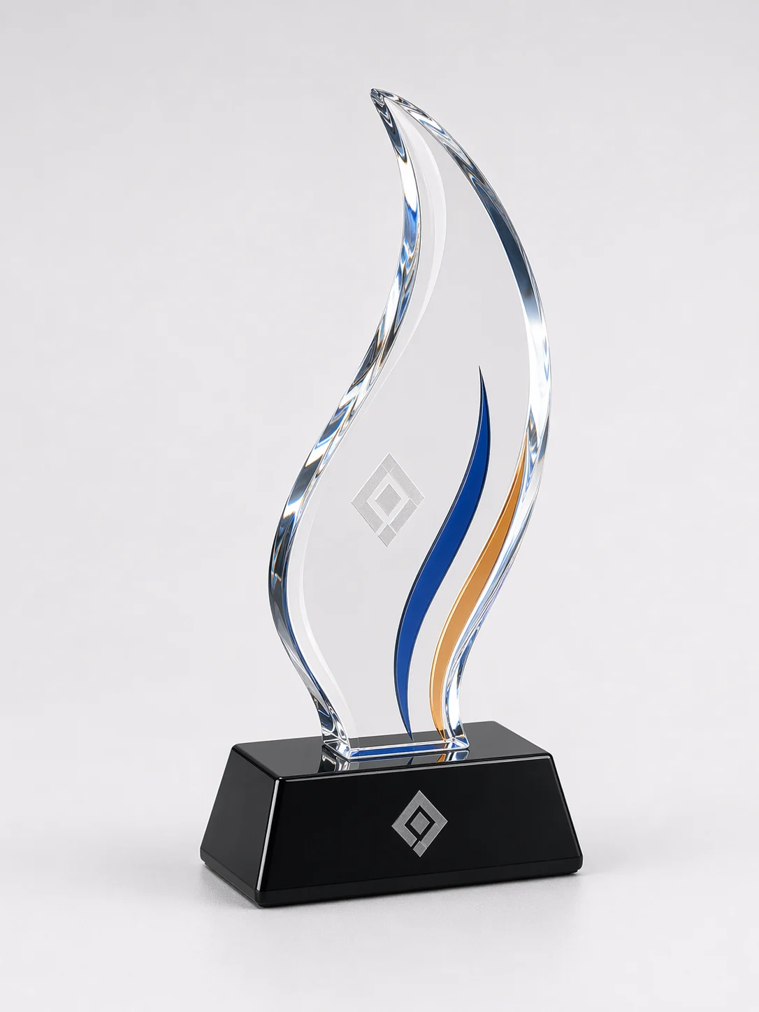 Freestanding flame-shaped acrylic trophy with an amber accent, diamond-polished edges, and a matte black base