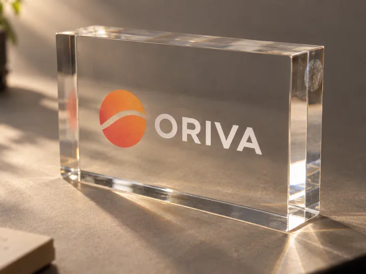 Clear acrylic block with a full-color ORIVA logo UV-printed on the back face over a white underlayer