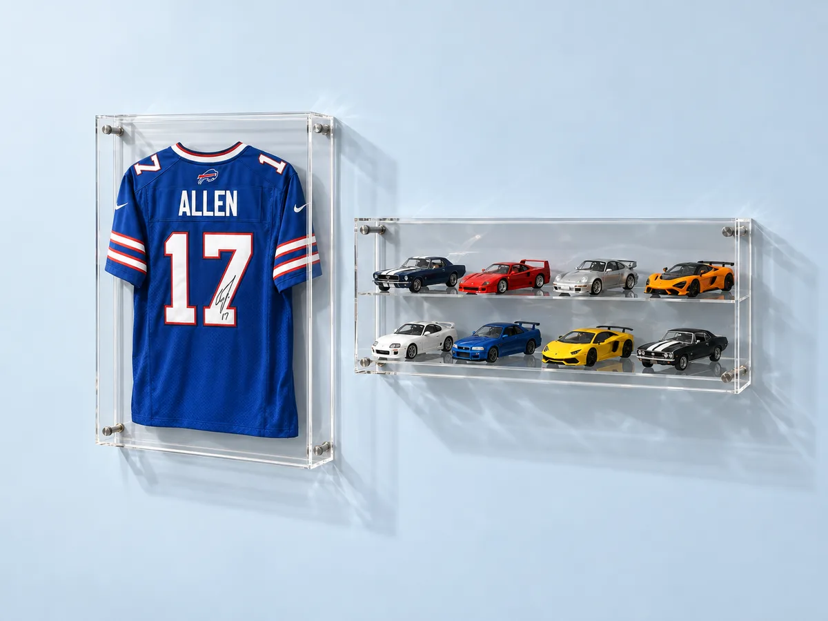 Wall-mounted display cases in clear acrylic on standoffs: a signed football jersey frame and a two-row die-cast car case