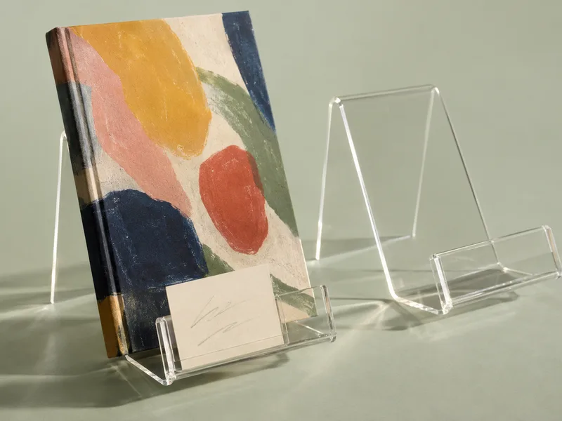 Clear acrylic book easel with a small card slot on the front lip holding a recommendation card