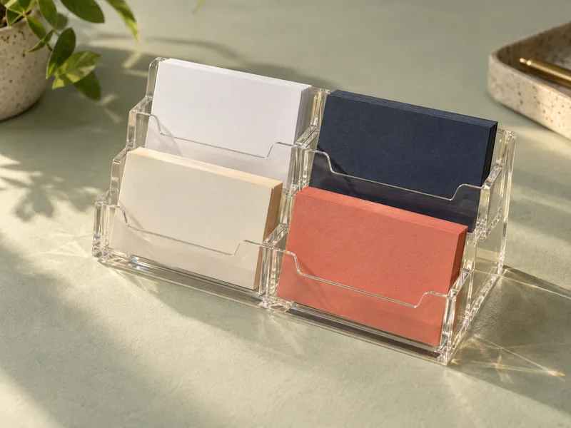 Four-pocket stepped clear acrylic business card holder with different colored card stacks