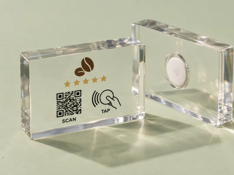 Clear acrylic block with reverse-printed QR code and a second block showing the NFC tag pocket on the back
