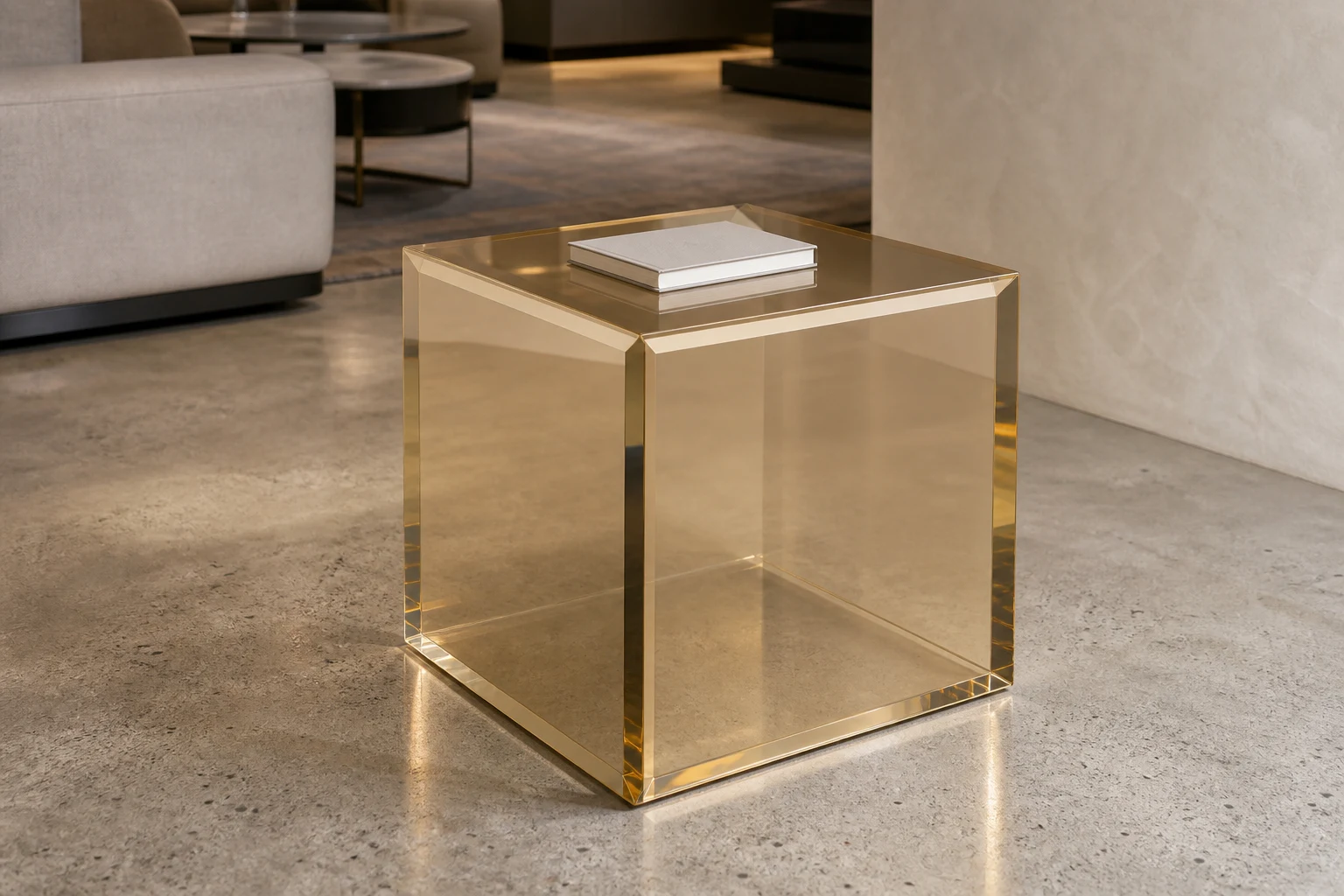 Solid clear cast acrylic cube side table next to a leather lounge armchair, mirror-polished faces and seamless mitered corners