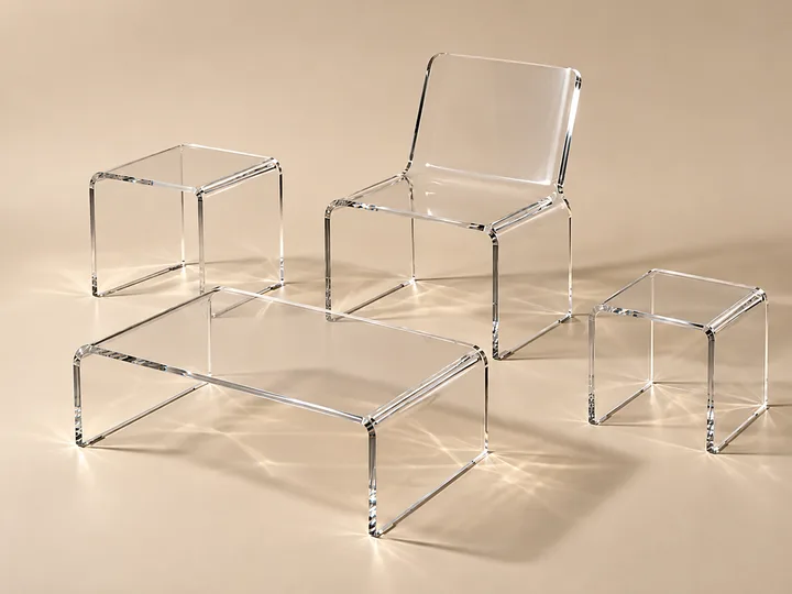 Matched set of clear acrylic furniture, coffee table, side tables and chairs, in a hotel lobby