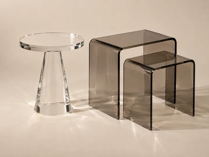 Amber-tinted acrylic pedestal side table with a round top