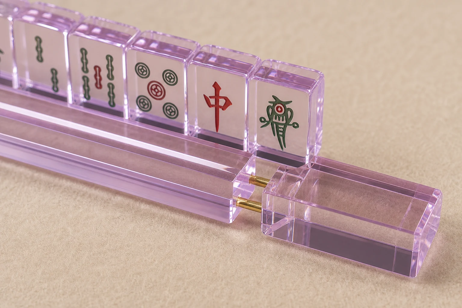 Editorial detail shot of a pastel mahjong rack-and-pusher set on a felted lounge surface — close-up of brass-pin pusher-to-rack integration with tile set partially visible above