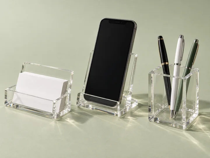 Clear acrylic business card holder, phone dock and pen cup for a reception desk