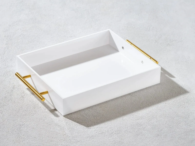 White acrylic hotel amenity tray with gold metal handles